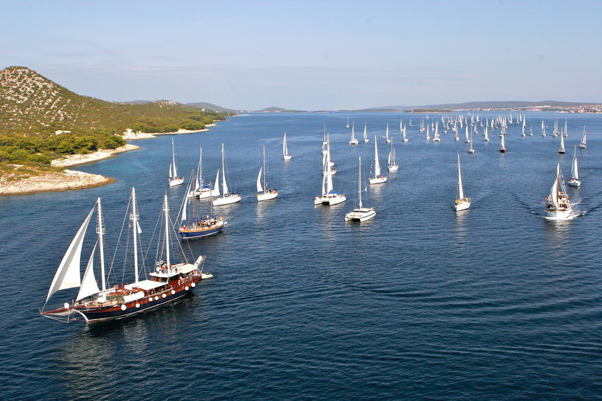 Formationsfahrt. 100 Boote segeln gemeinsam der Küste entlang. 